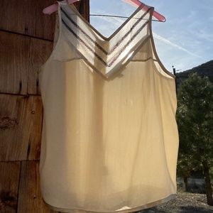 Cream colored silk sleeveless blouse